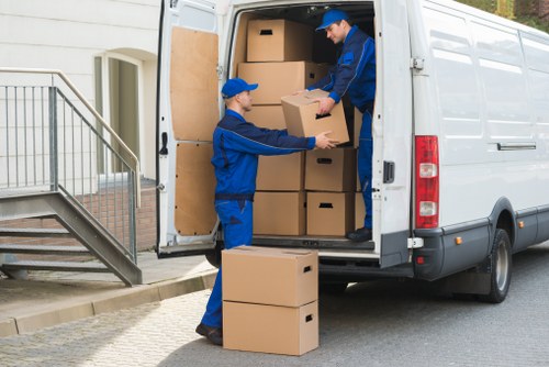 Removal team assisting with a home move in a local residential street