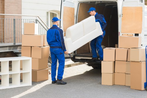 Packed boxes and furniture prepared for transport by removals van