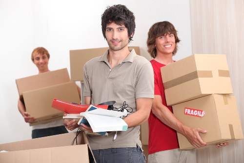 Local man with van removal team loading boxes and furniture
