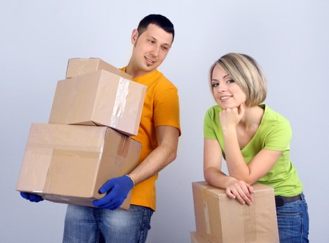 Local removals team handling furniture in a family home move