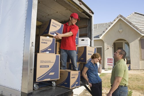 Movers loading furniture and boxes into a removal truck