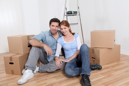 Movers carrying office furniture through a building with careful planning
