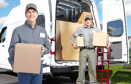 Packed boxes and wrapped furniture ready for transport during a home removal