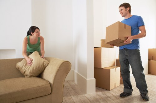 Removals team packing household items carefully for transport